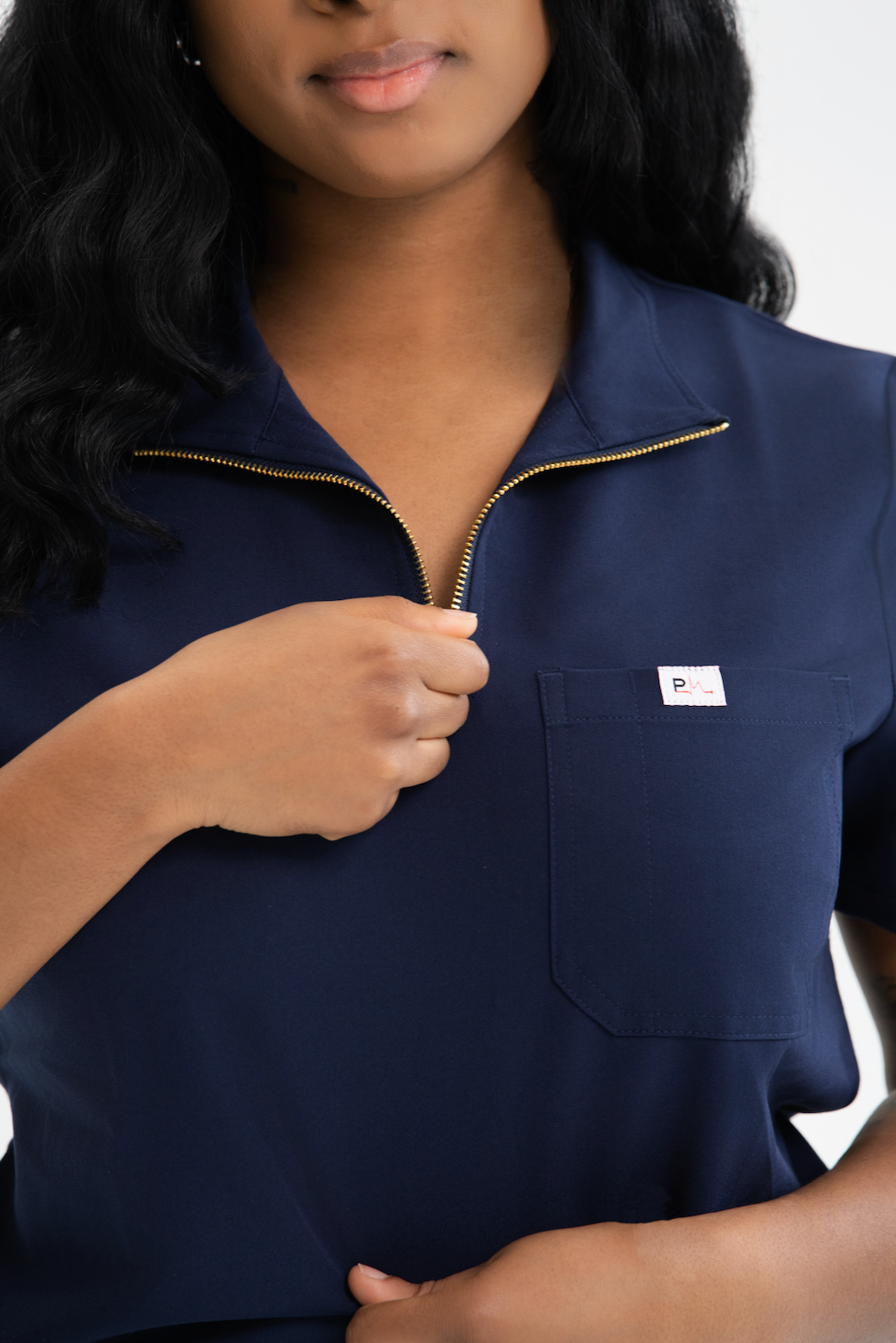 Close-up of a Pulsara Wear zip-front scrub top