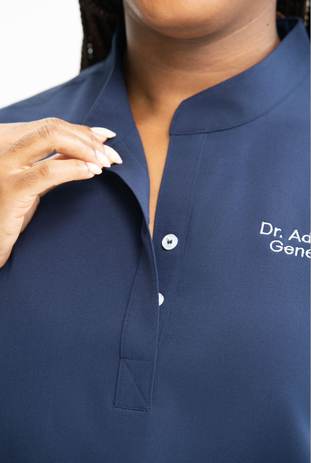 Close-up of a Pulsara Wear button-front scrub top